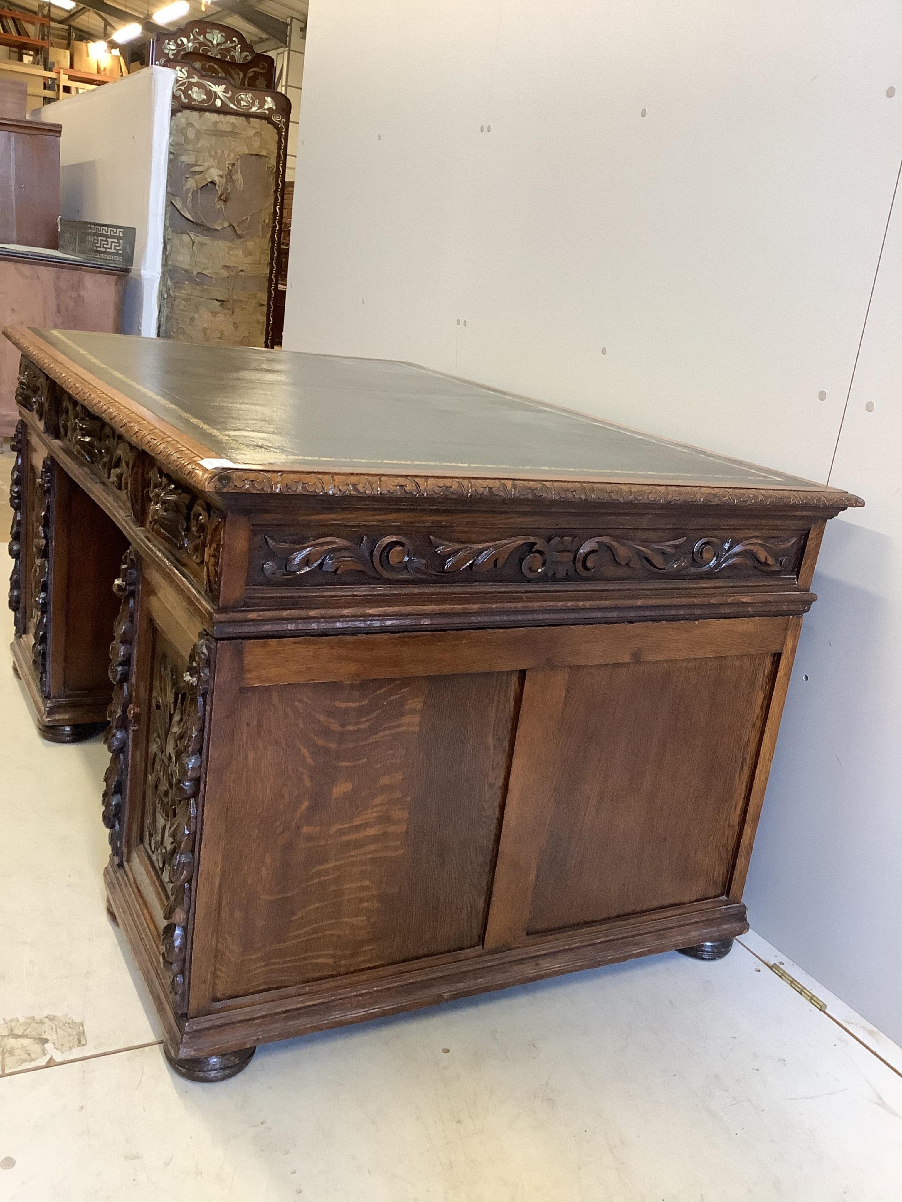 A Victorian carved oak pedestal desk, width 148cm, depth 92cm, height 78cm. Condition - good
